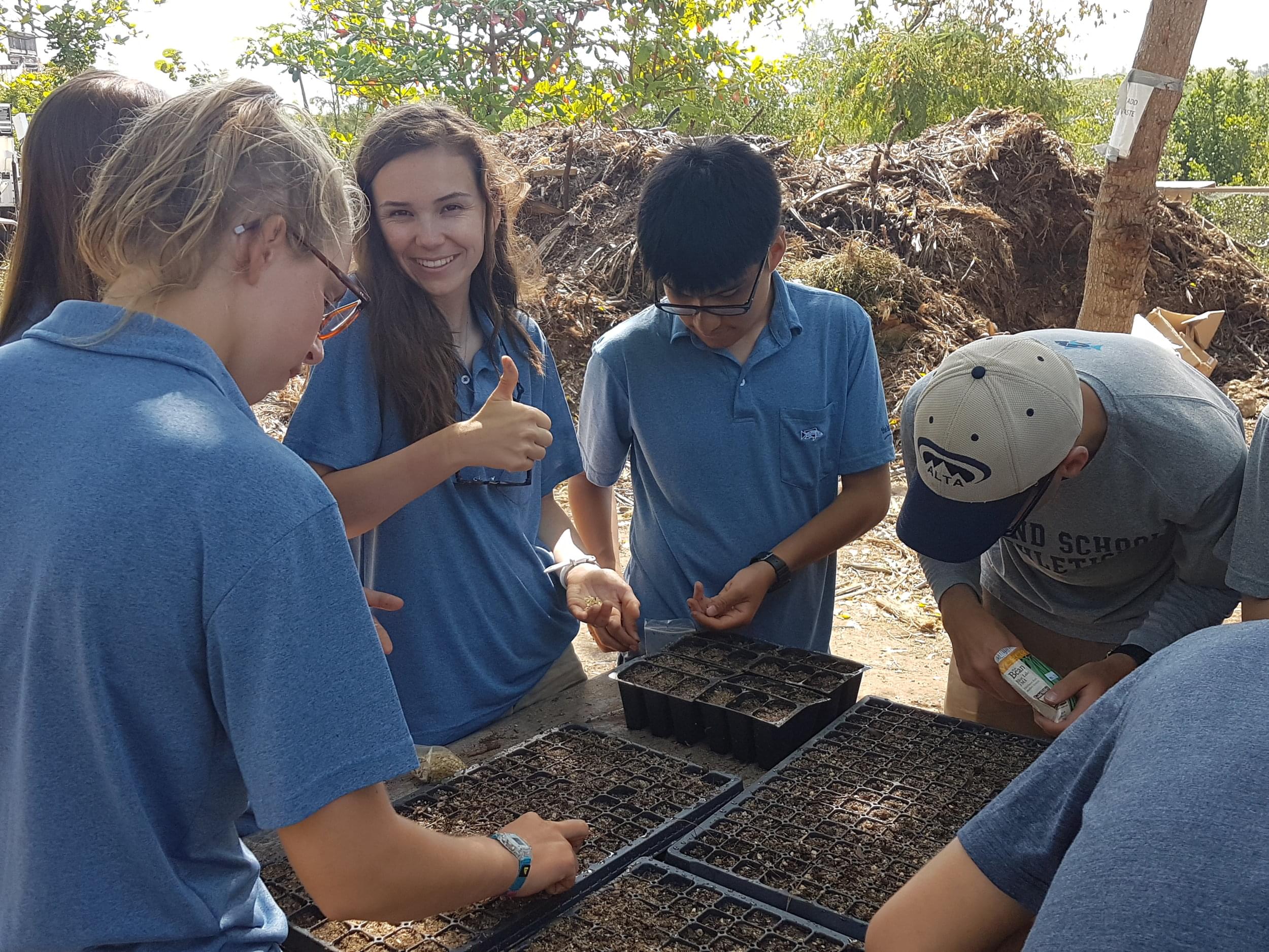 The Research team plants seeds to then be transplanted into the new grow beds in the farm.