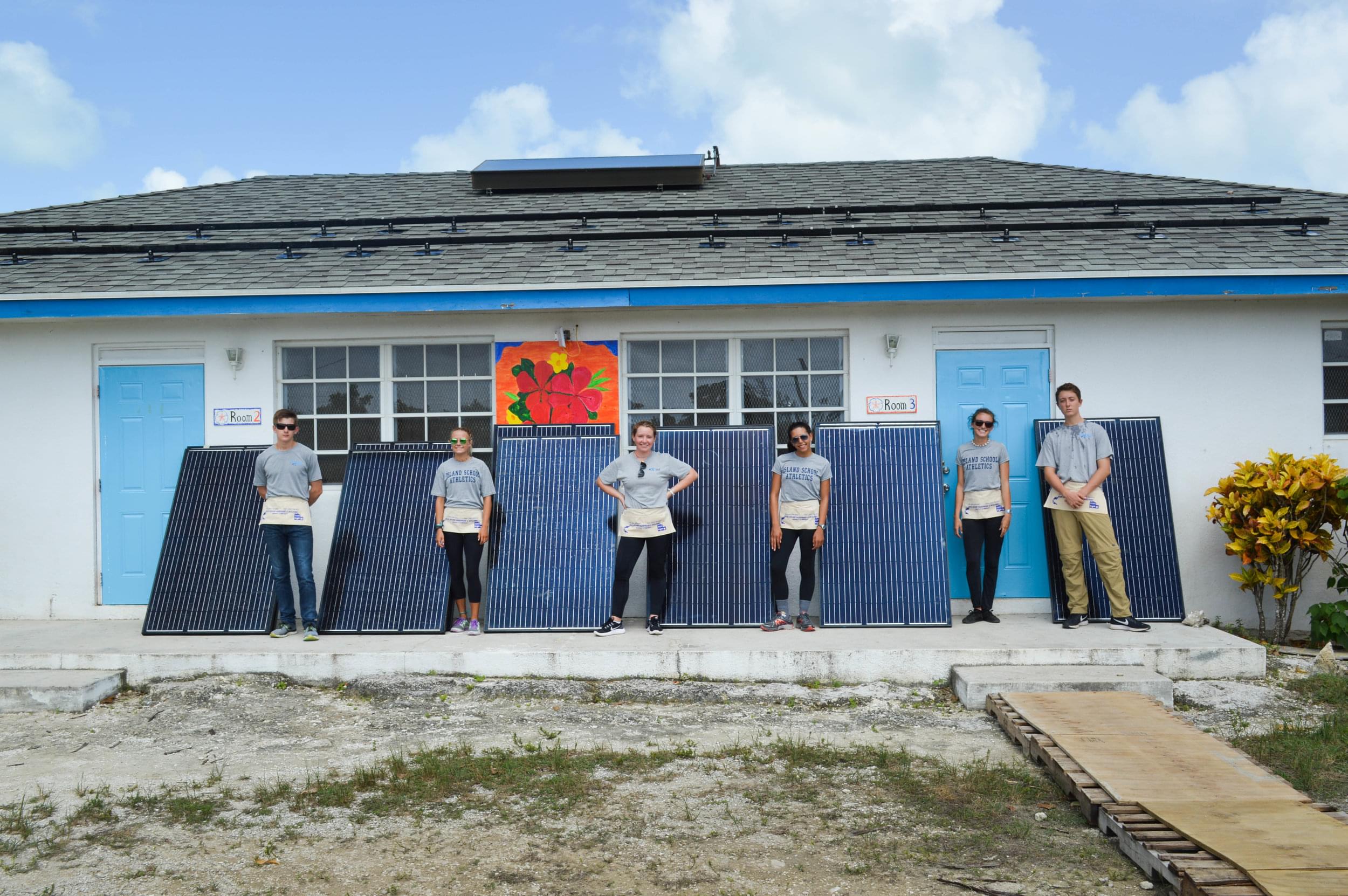 Island School students stand with the solar PV modules before they helped to install them. 