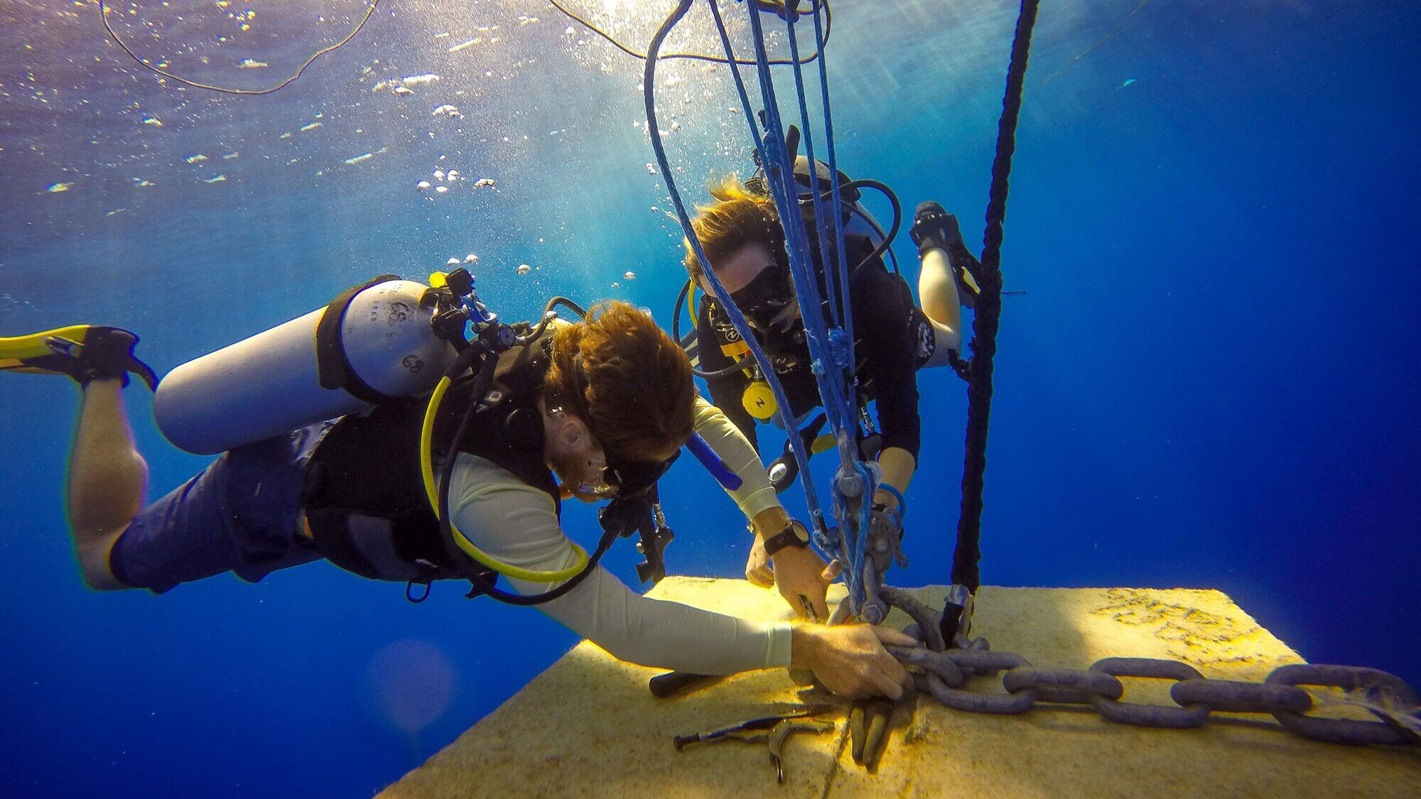 Divers attach the mooring line to the FAD anchor block during the deployment of CEI's research FADs.