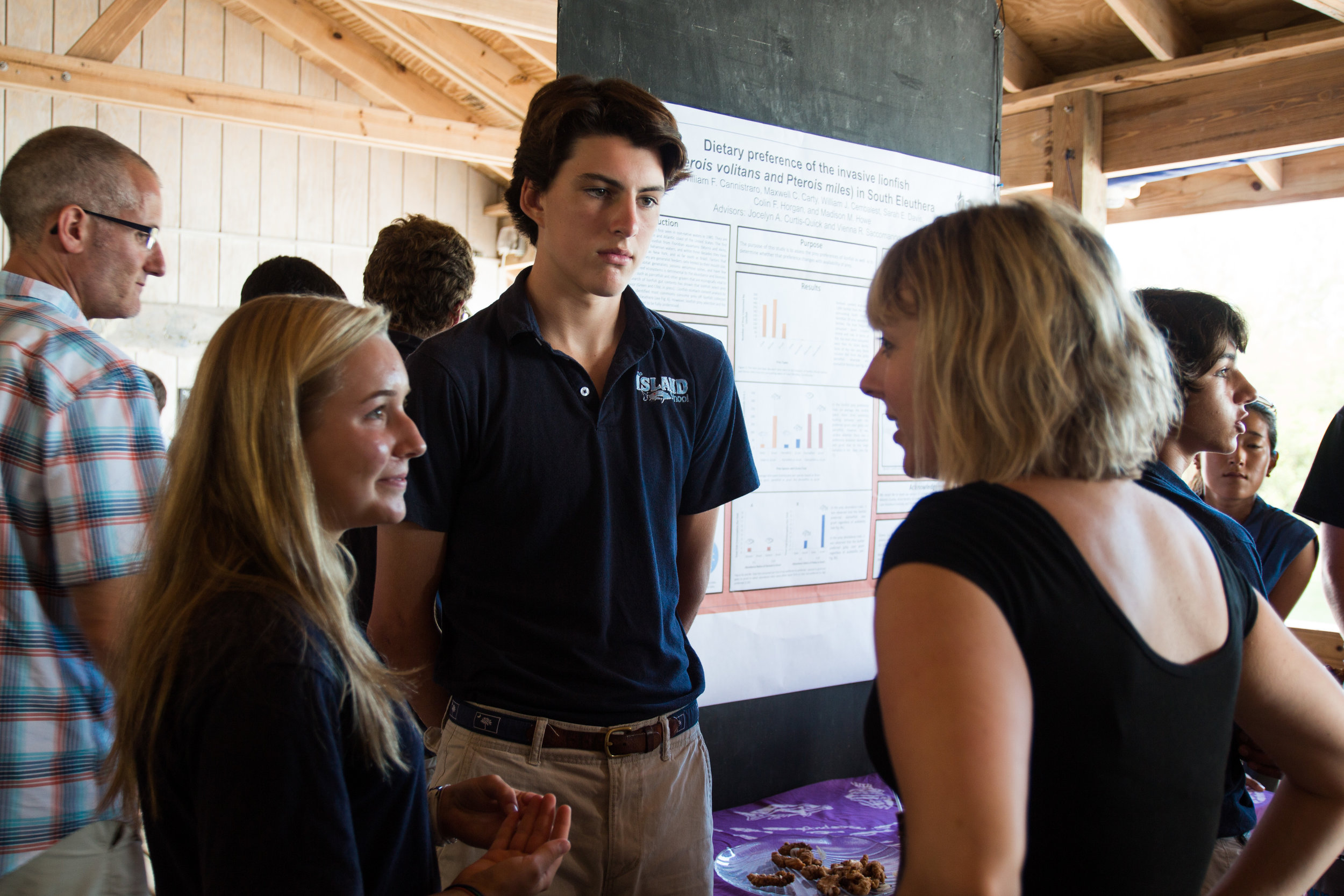 Students on the lionfish team discuss their project with Dr. Stephanie Green.