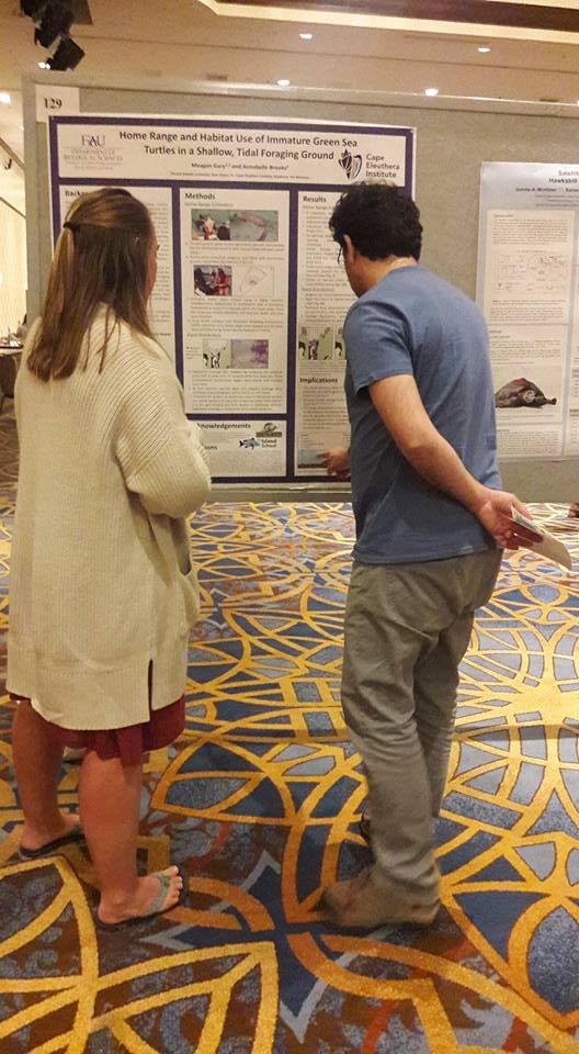 Meagan discussing her research with symposium attendees