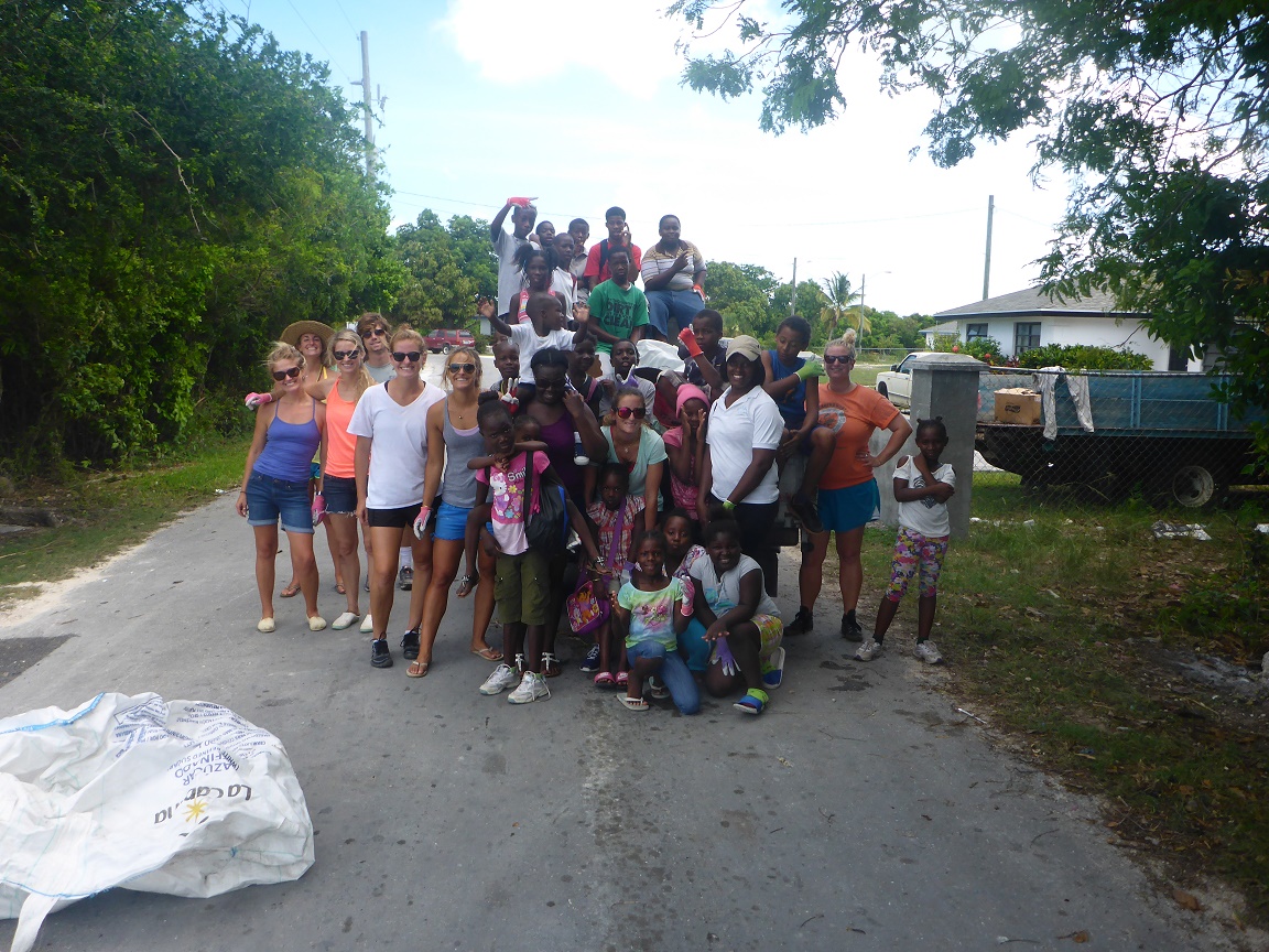  The clean up team posing in front of one of the truckloads of trash collected.